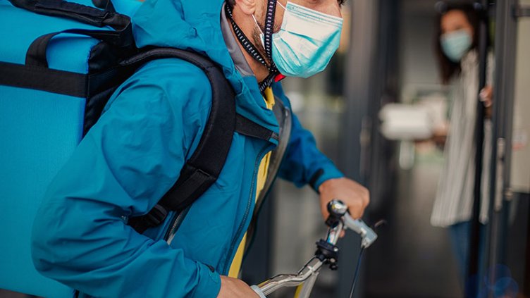 Men delivering the grocery and food items in bicycle during pandemic